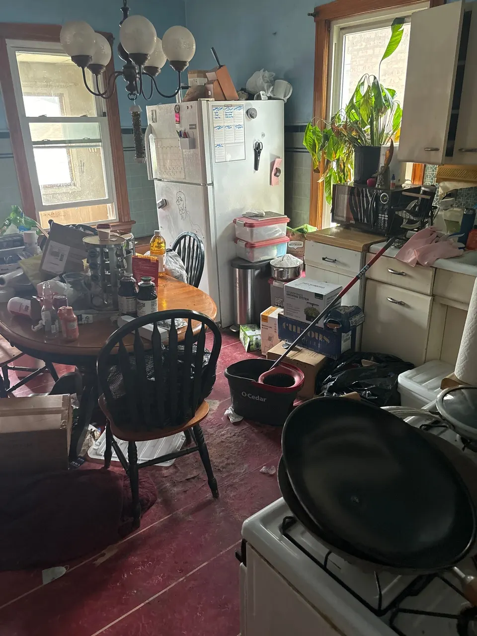 Outdated Archer Heights kitchen with belongings before an as-is sale